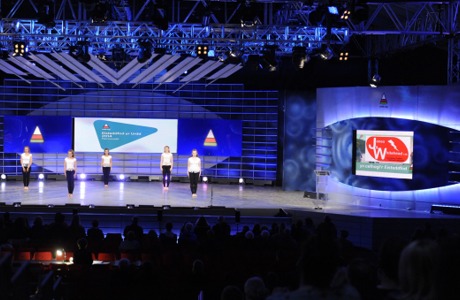 Urdd Eisteddfod pavilion stage with the Jones & Whitehead logo on screen